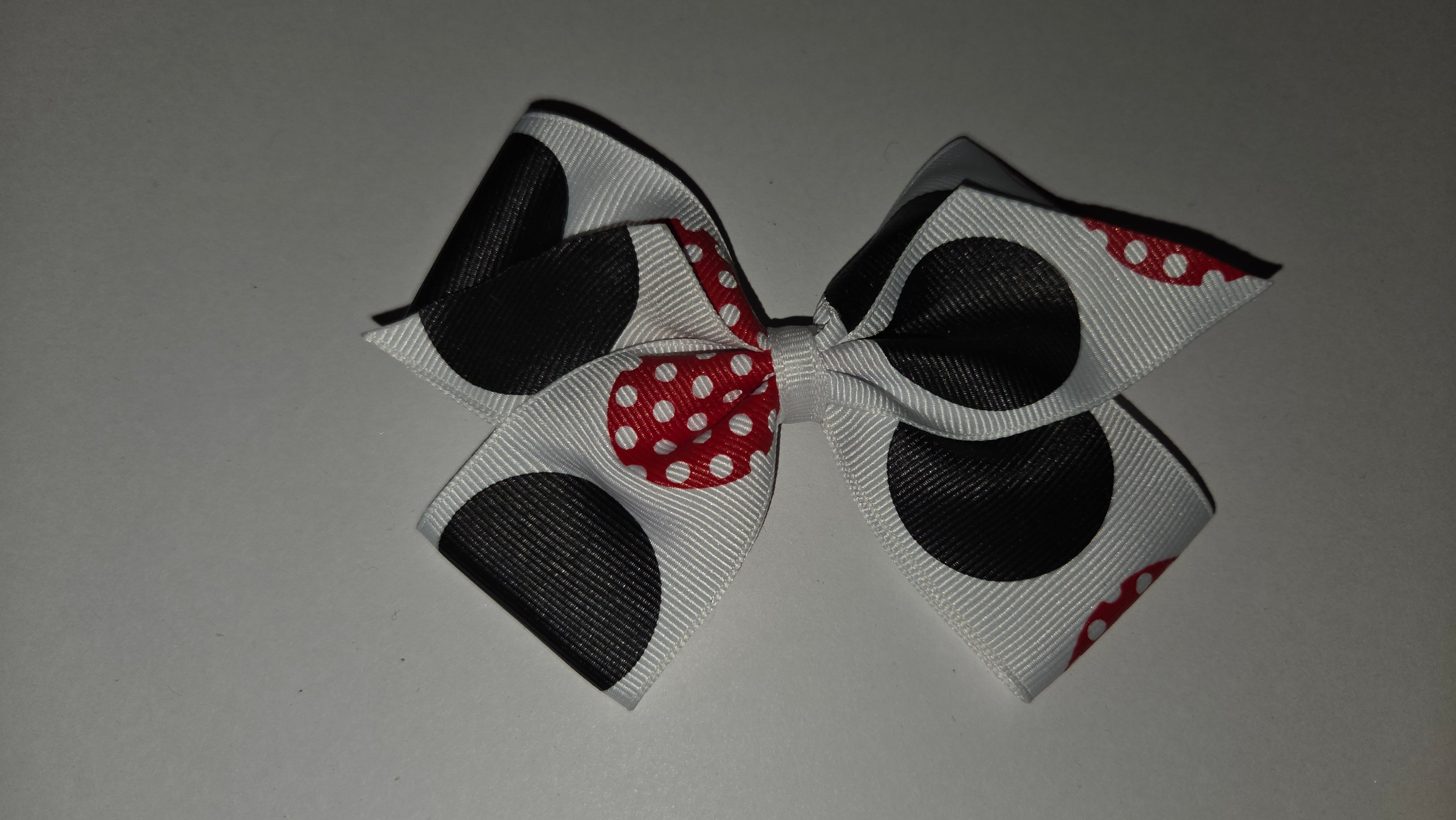 White with black and red dots